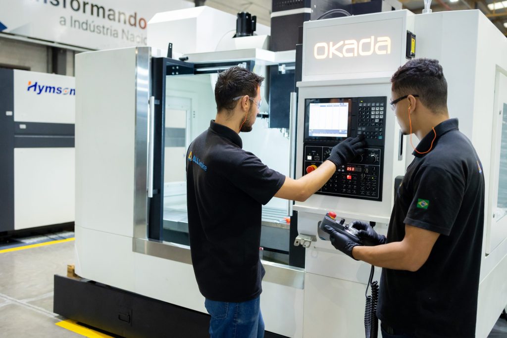 Técnicos da Alltech Service em operação de máquina industrial, garantindo manutenção especializada e suporte completo